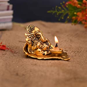 Lord Ganesh Idol on Leaf with Diya