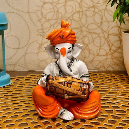 Karigaari India Karigaari Polyresine Orange & White Ganesha Playing Dholak