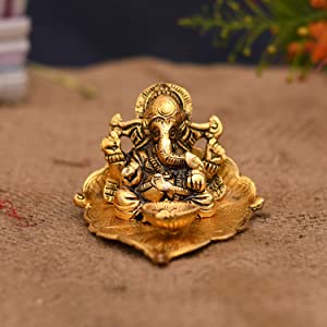 Lord Ganesh Idol on Leaf with Diya